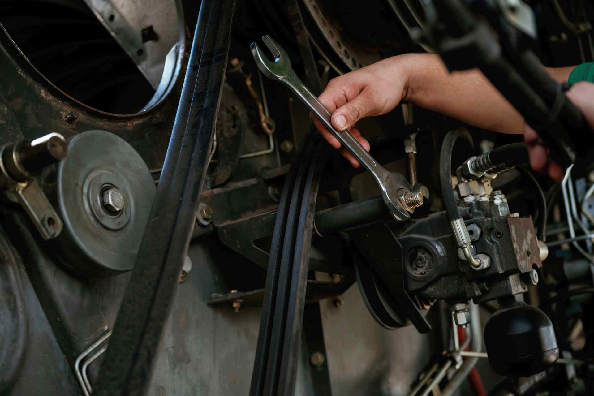 Mechanic troubleshooting a belt drive system