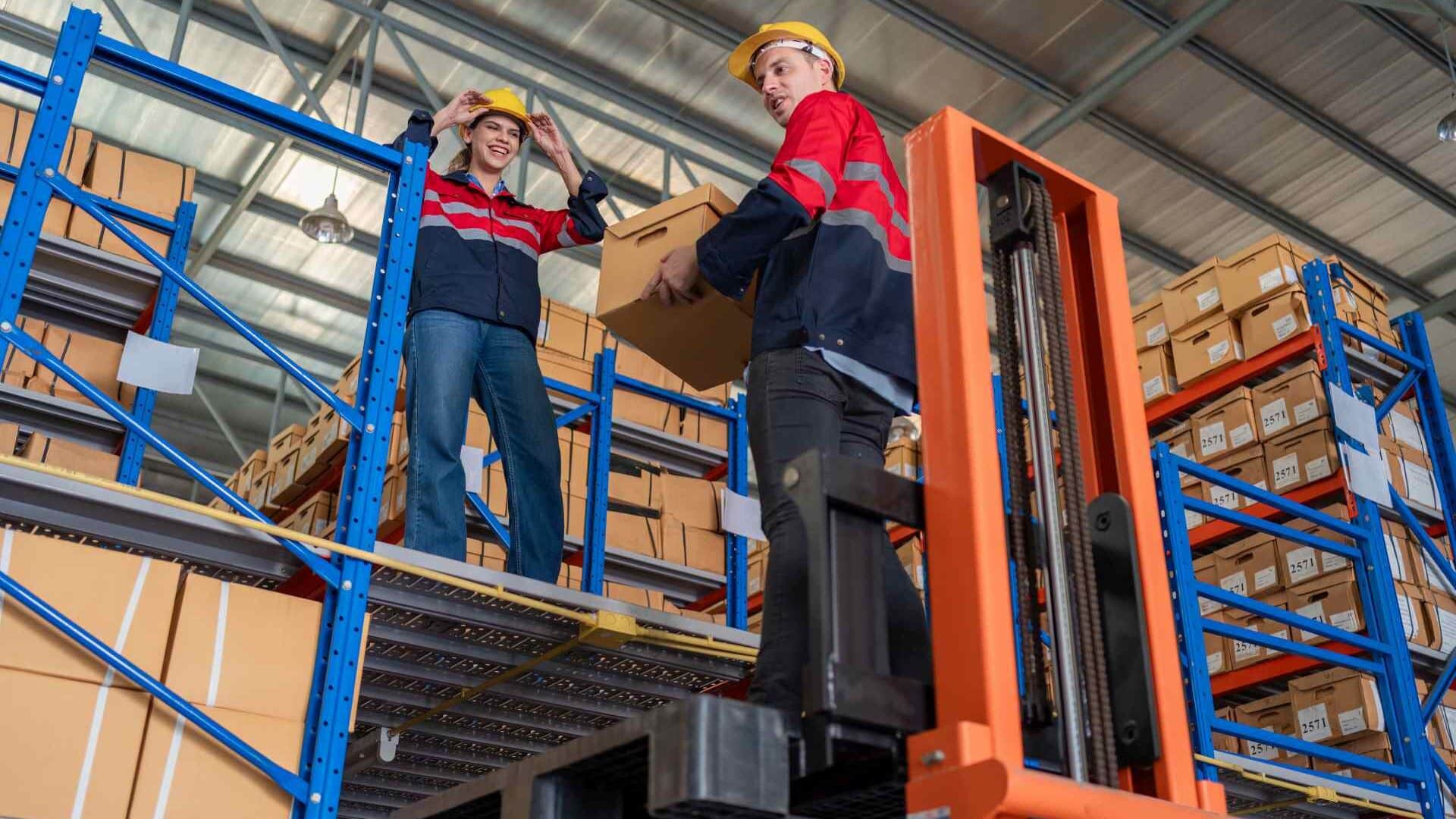 Workers using ergonomic material handling equipment.