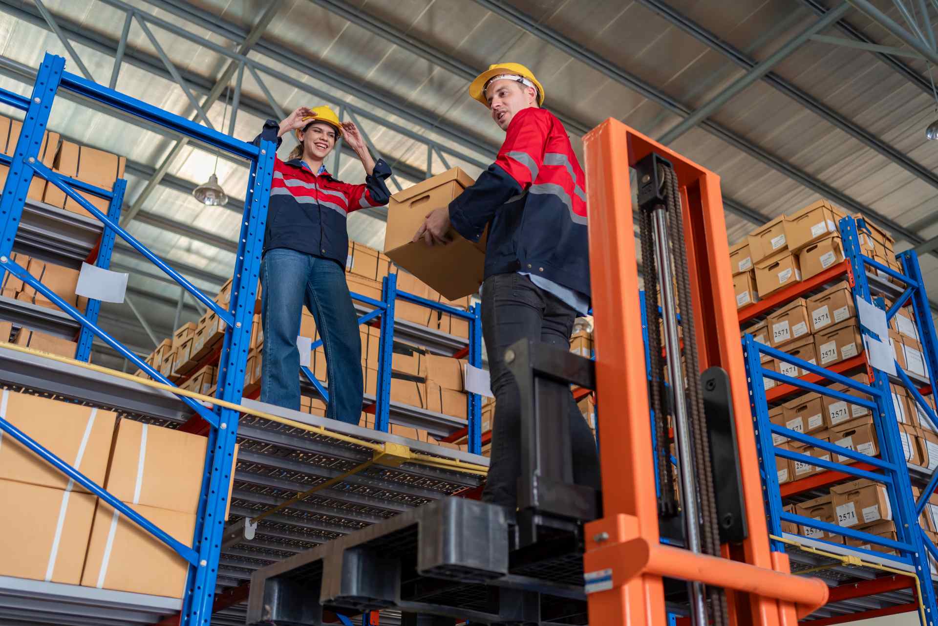 Workers using ergonomic material handling equipment.