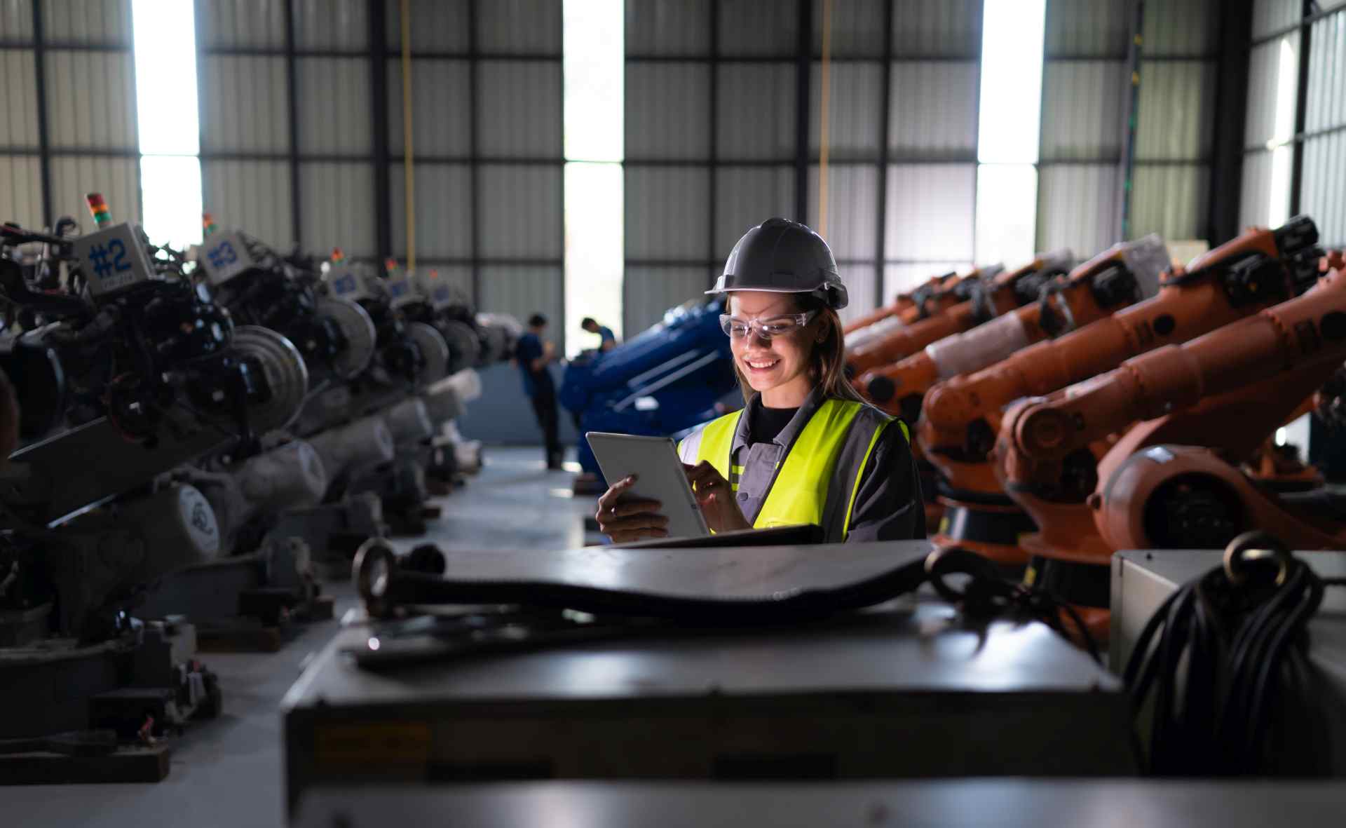Worker smiling near construction machinery