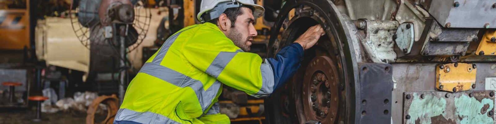 Maintenance worker inspecting large industrial gear