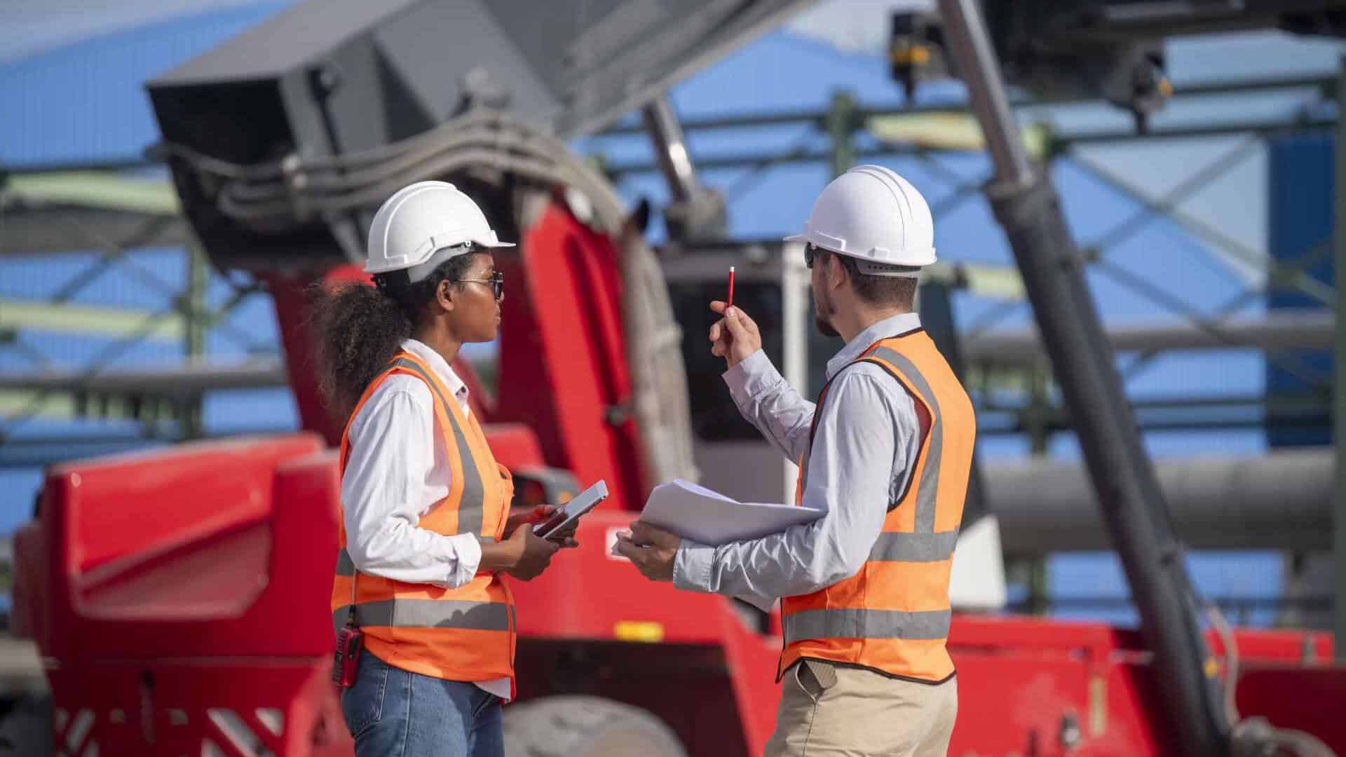 Industrial workers discussing at construction site