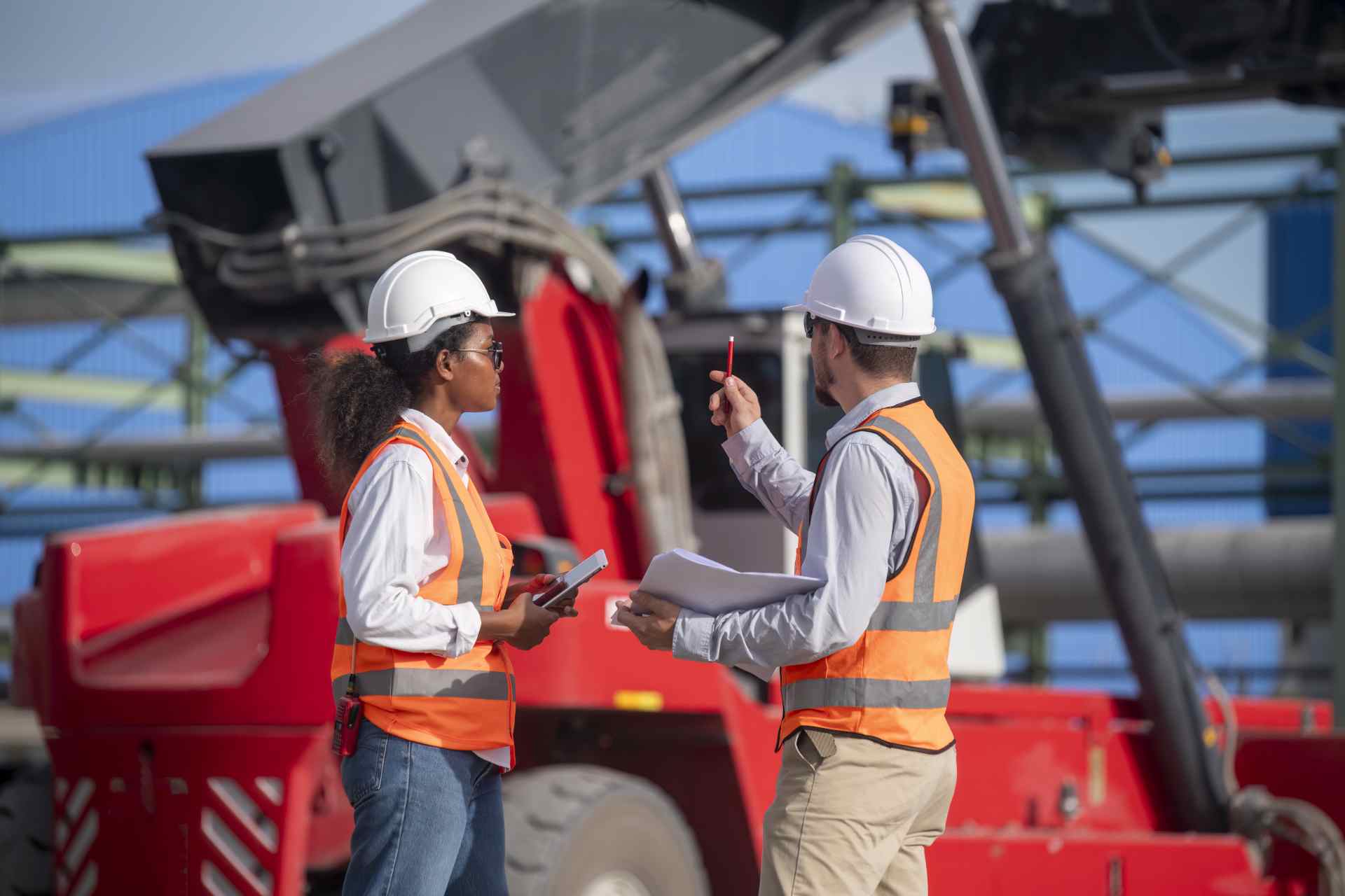 Industrial workers discussing at construction site