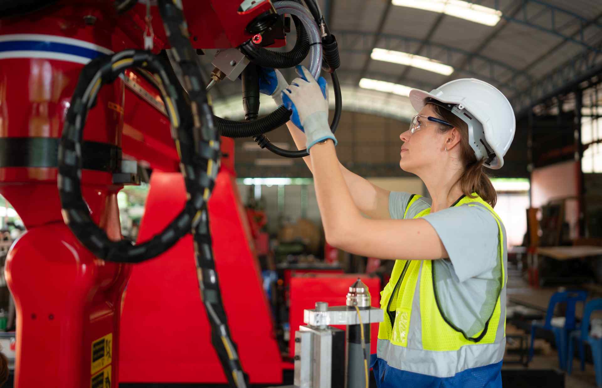 Technician inspecting robotics to prevent equipment breakdown